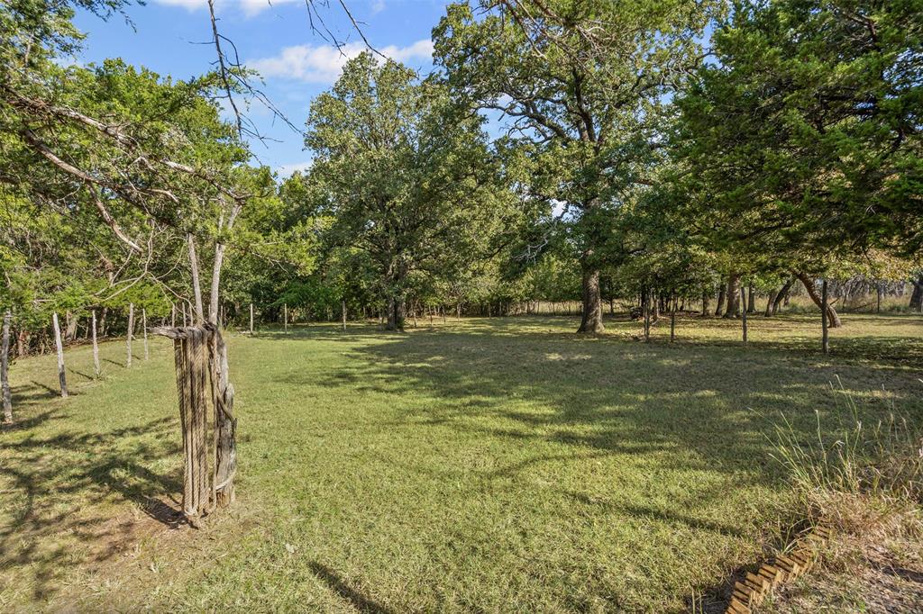 3667 Oak Circle Weatherford, TX 76088 - Photo 14 of 35 View of green lawn featuring view of scattered trees