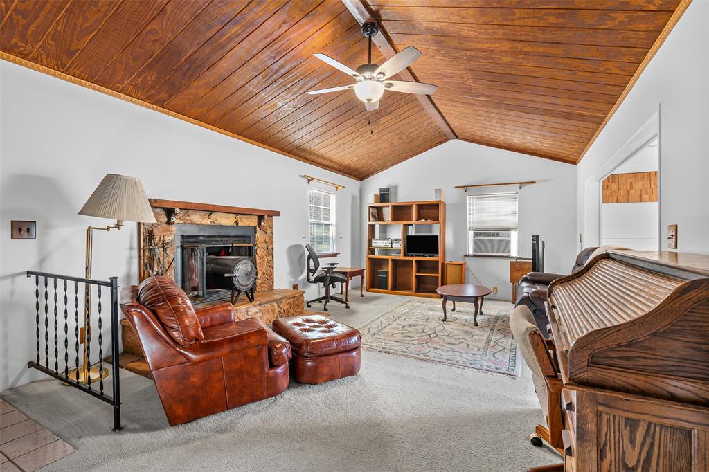 3667 Oak Circle Weatherford, TX 76088 - Photo 2 of 35 Carpeted living area with wooden ceiling, lofted ceiling, a fireplace, and ceiling fan