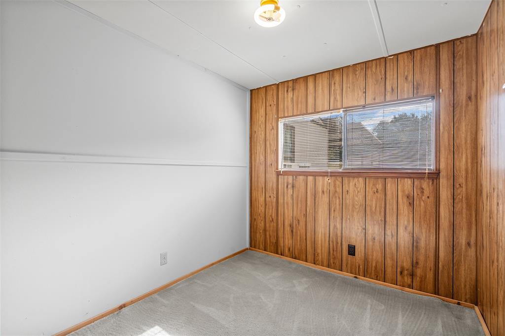 3667 Oak Circle Weatherford, TX 76088 - Photo 23 of 35 Empty room with wooden walls and carpet