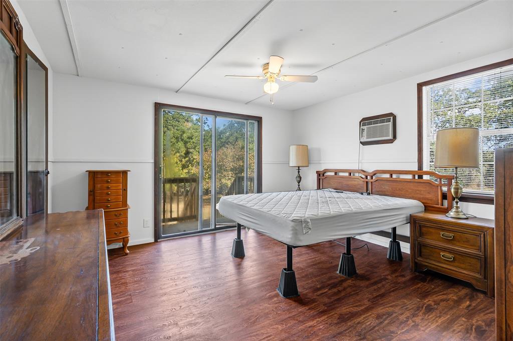 3667 Oak Circle Weatherford, TX 76088 - Photo 27 of 35 Rec room with dark wood-style floors, ceiling fan, healthy amount of natural light, and an AC wall unit