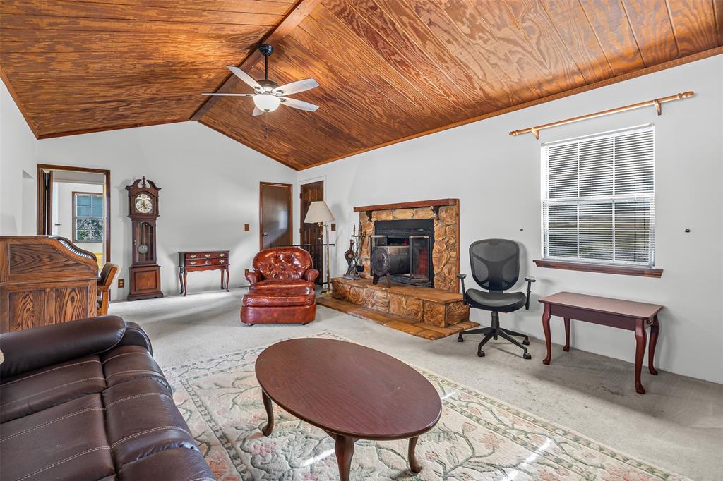 3667 Oak Circle Weatherford, TX 76088 - Photo 3 of 35 Living room with carpet floors, lofted ceiling, a fireplace, wooden ceiling, and a ceiling fan