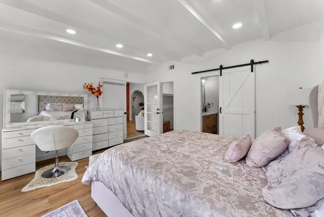 a bedroom with a bed a desk and chair