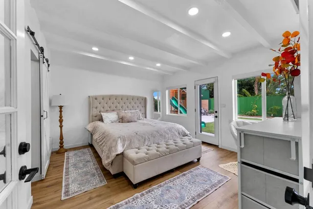 a bedroom with a large bed and a window