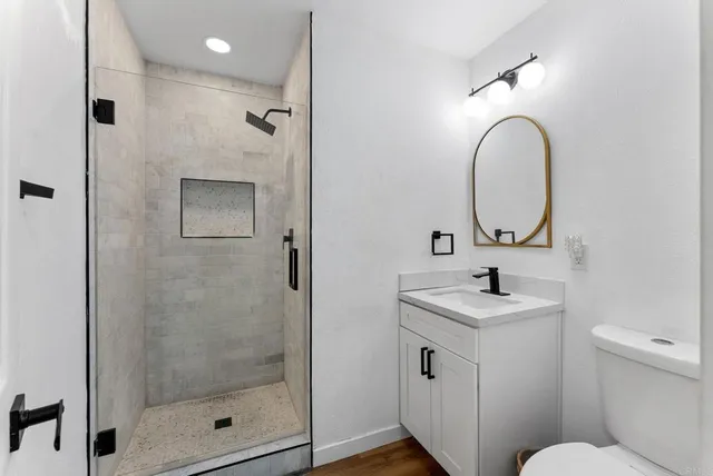 a bathroom with a toilet sink and shower