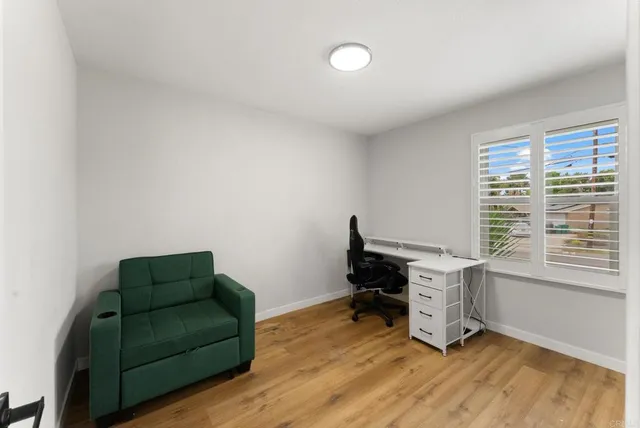 a livingroom with workspace and a window