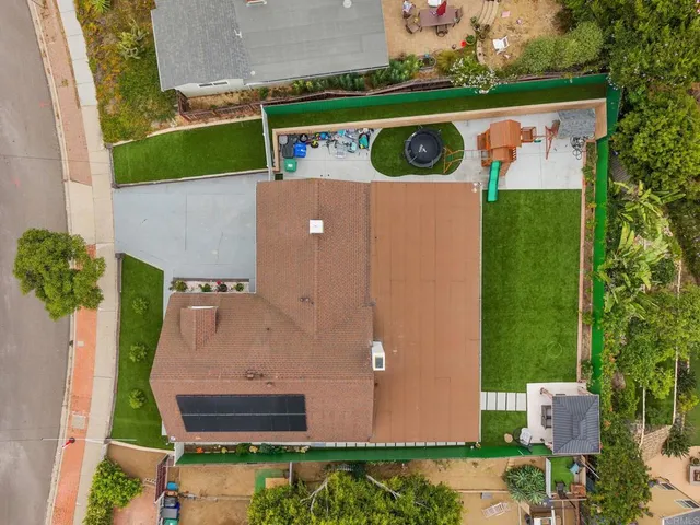 an aerial view of house with yard and outdoor seating