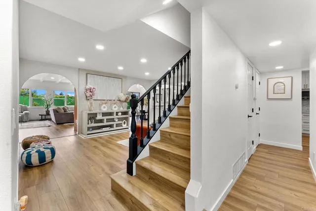 a view of entryway and hall with wooden floor