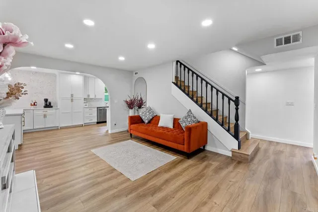 a view of a living room and entryway with wooden floor