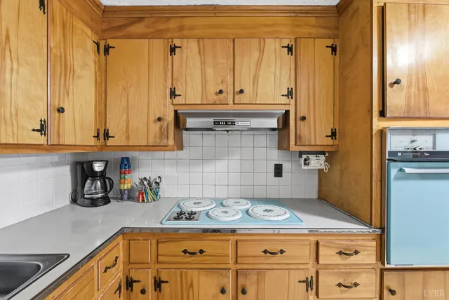 a kitchen with granite countertop a stove a sink and dishwasher
