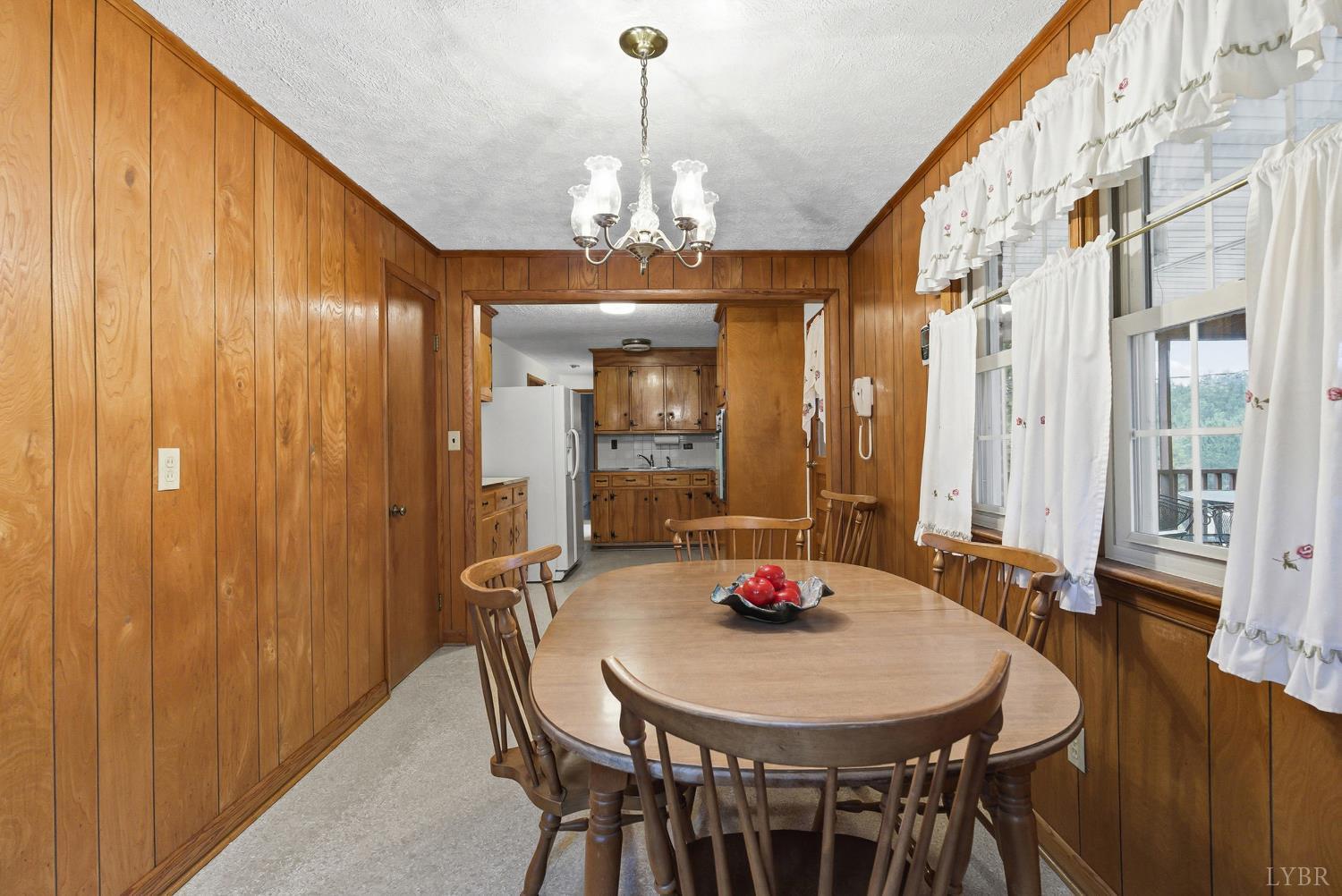 1760 Wickliffe Road Brookneal, VA 24528 - Photo 13 of 40 a view of a dining room with furniture and wooden floor