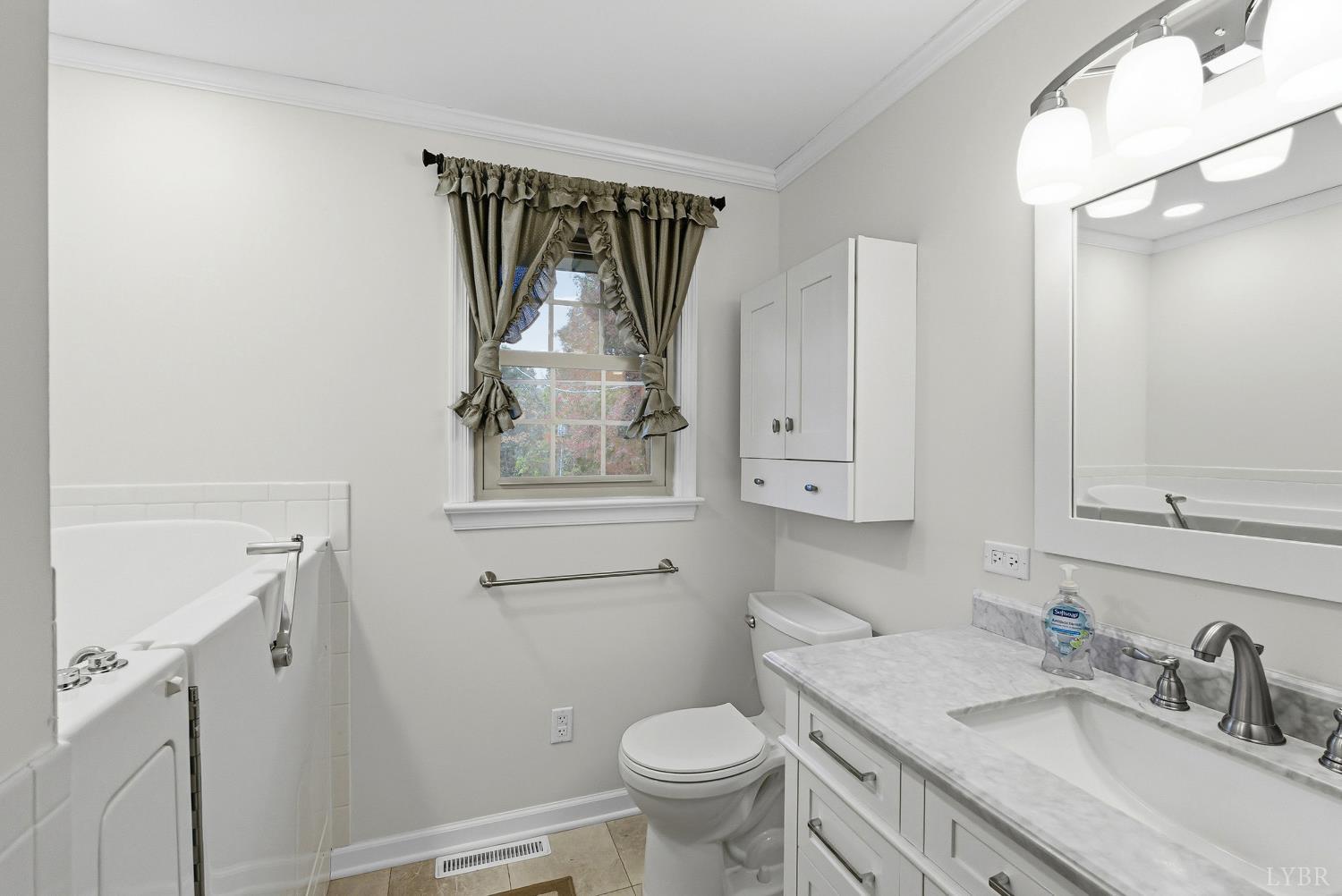 1760 Wickliffe Road Brookneal, VA 24528 - Photo 15 of 40 a bathroom with a granite countertop sink toilet and mirror
