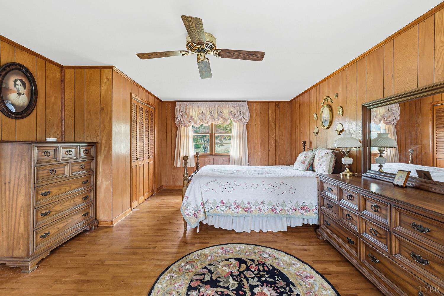1760 Wickliffe Road Brookneal, VA 24528 - Photo 18 of 40 a spacious bedroom with a bed a dresser and potted plants