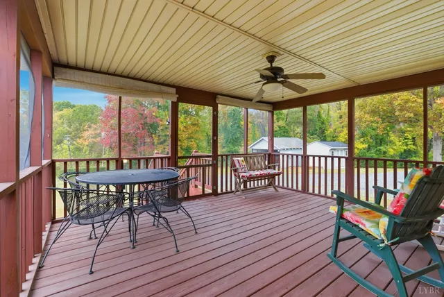 a view of a patio with a table chairs and a barbeque
