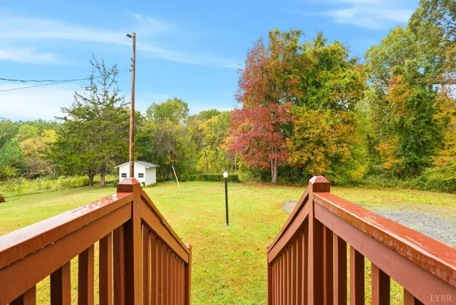 a view of swimming pool with garden and deck