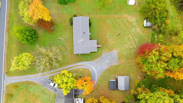an aerial view of a house with a swimming pool and outdoor space