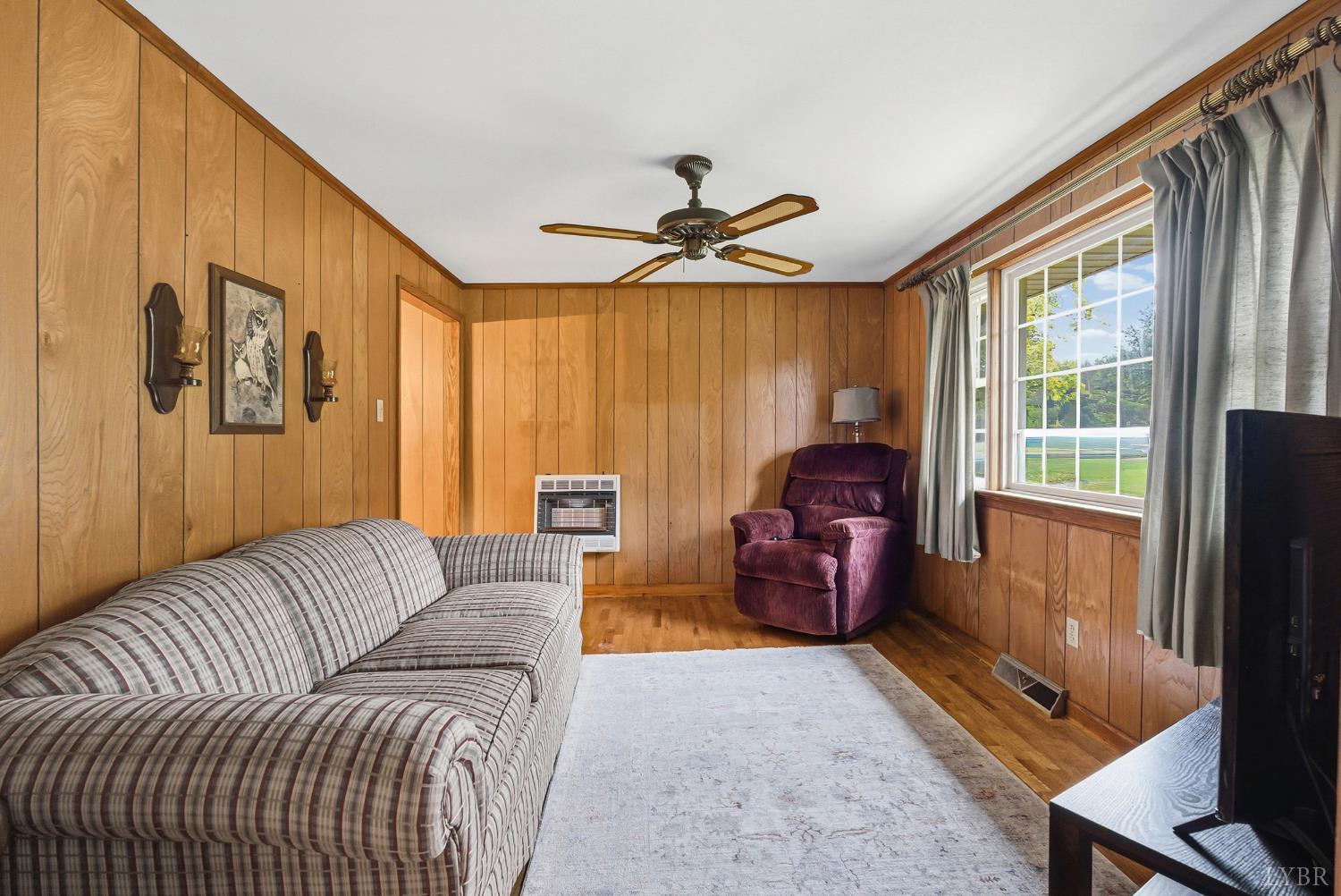 1760 Wickliffe Road Brookneal, VA 24528 - Photo 6 of 40 a living room with furniture and a flat screen tv