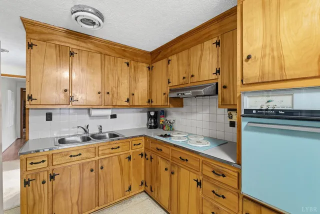 a kitchen with stainless steel appliances granite countertop a sink and cabinets