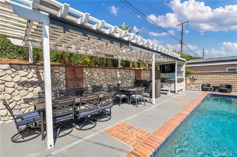 a view of a patio with couches fire pit and chairs