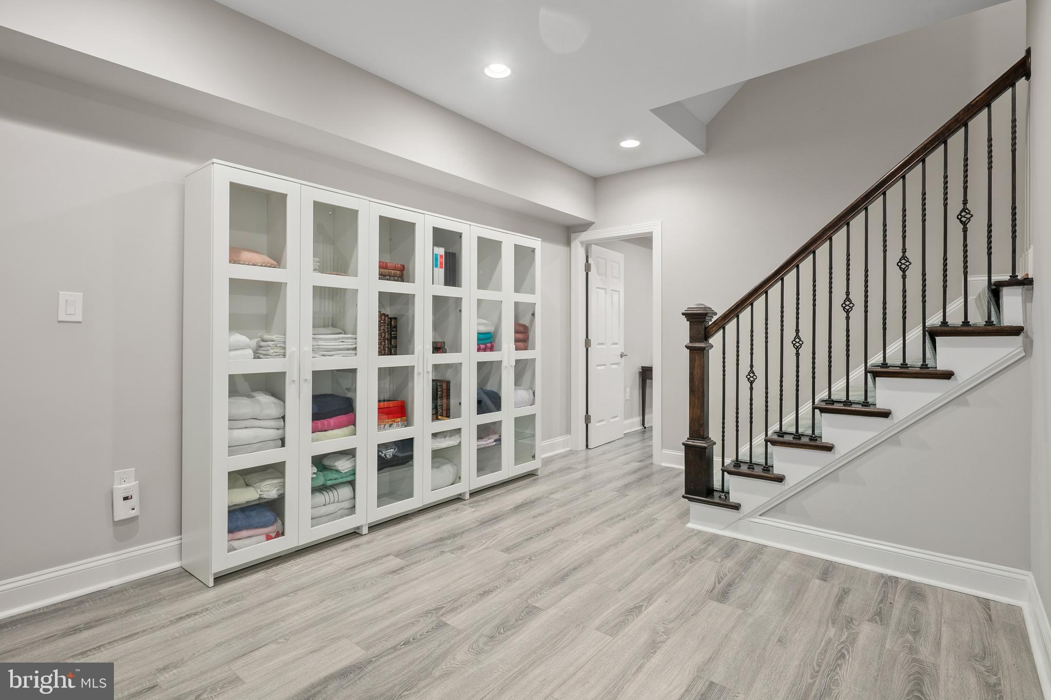 7911 Fort Hunt Road Alexandria, VA 22308 - Photo 53 of 71 LL wall of glass-front shelves, Luxury Vinyl Plank