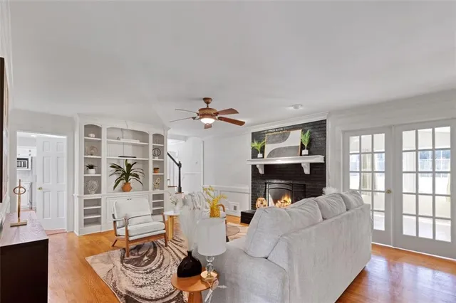 a living room with furniture a fireplace and a window