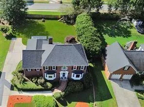 a view of a house with a yard and a garage