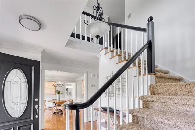 a view of entryway and hall with wooden floor