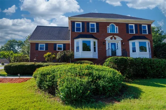 a front view of a house with a yard