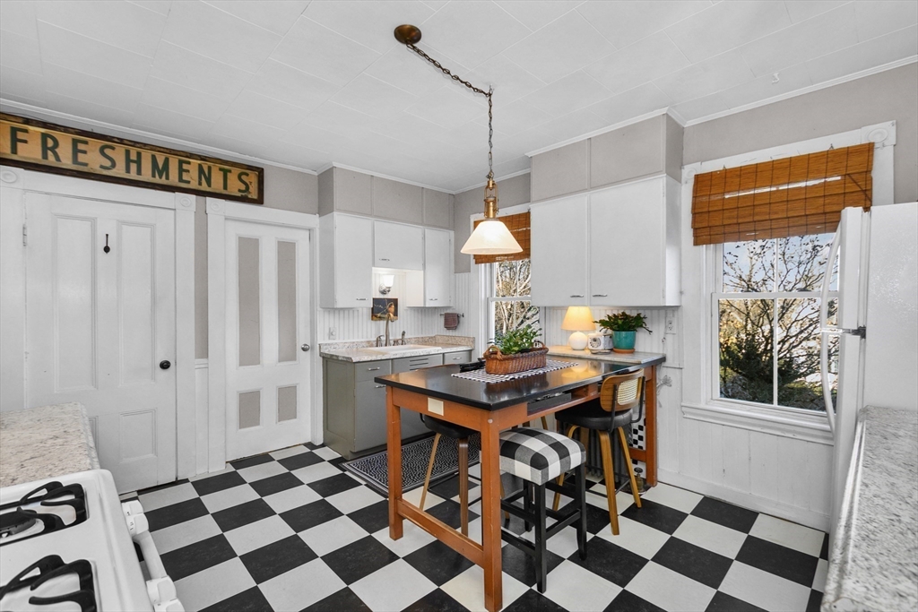 41 Walnut Street Hudson, MA 01749 - Photo 3 of 15 a kitchen with stainless steel appliances a dining table chairs and a sink