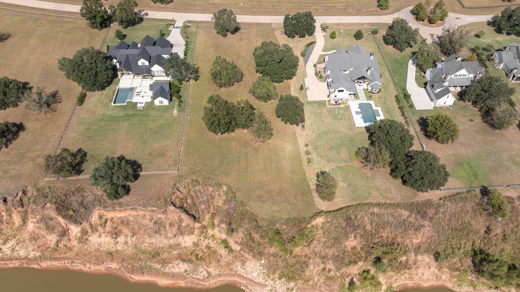 an aerial view of a residential houses with yard