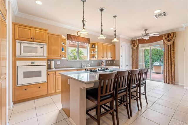 a large kitchen with kitchen island granite countertop lots of white cabinets