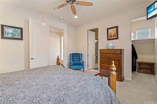 a bedroom with furniture and a chandelier
