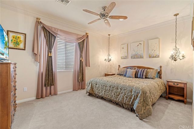 a bedroom with a bed and a television