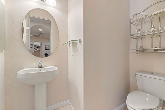 a living room with furniture and a mirror