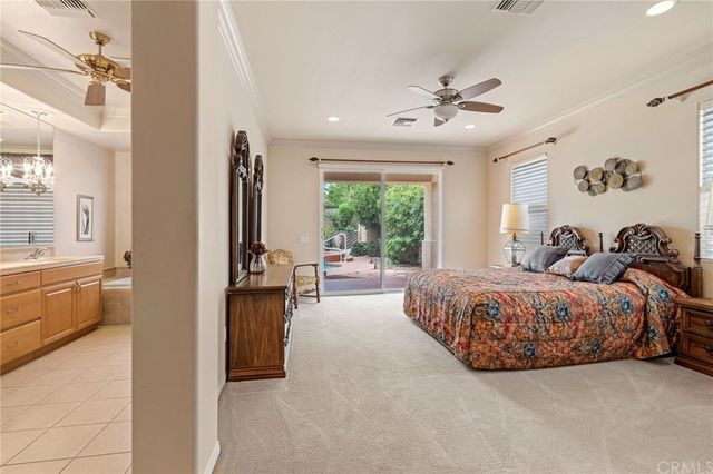 a bedroom with a bed and dresser with mirror