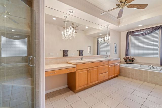 a large bathroom with a granite countertop sink a toilet a mirror and bathtub