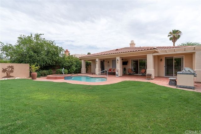 a view of a house with swimming pool and a garden