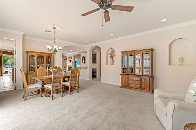 a living room with furniture and large windows