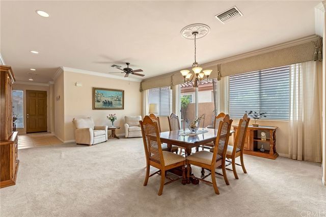 a view of a dining room with furniture and a chandelier