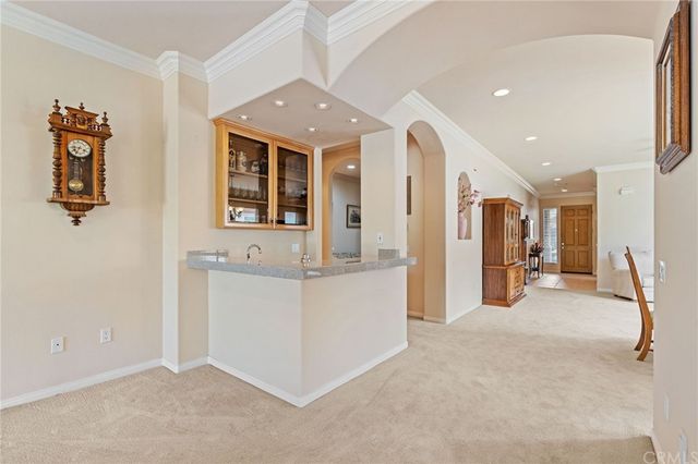a living room with furniture and large windows