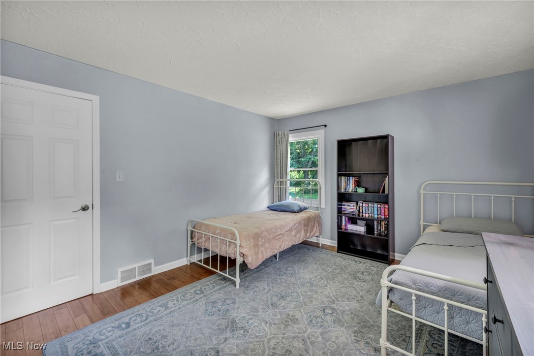 2264 Acre Road Akron, OH 44320 - Photo 24 of 47 Bedroom with bamboo finished floors and a textured ceiling