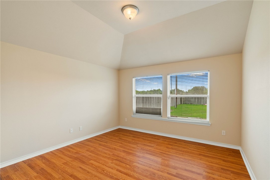 6606 Riding Wind Drive Corpus Christi, TX 78414 - Photo 9 of 15 an empty room with wooden floor and windows
