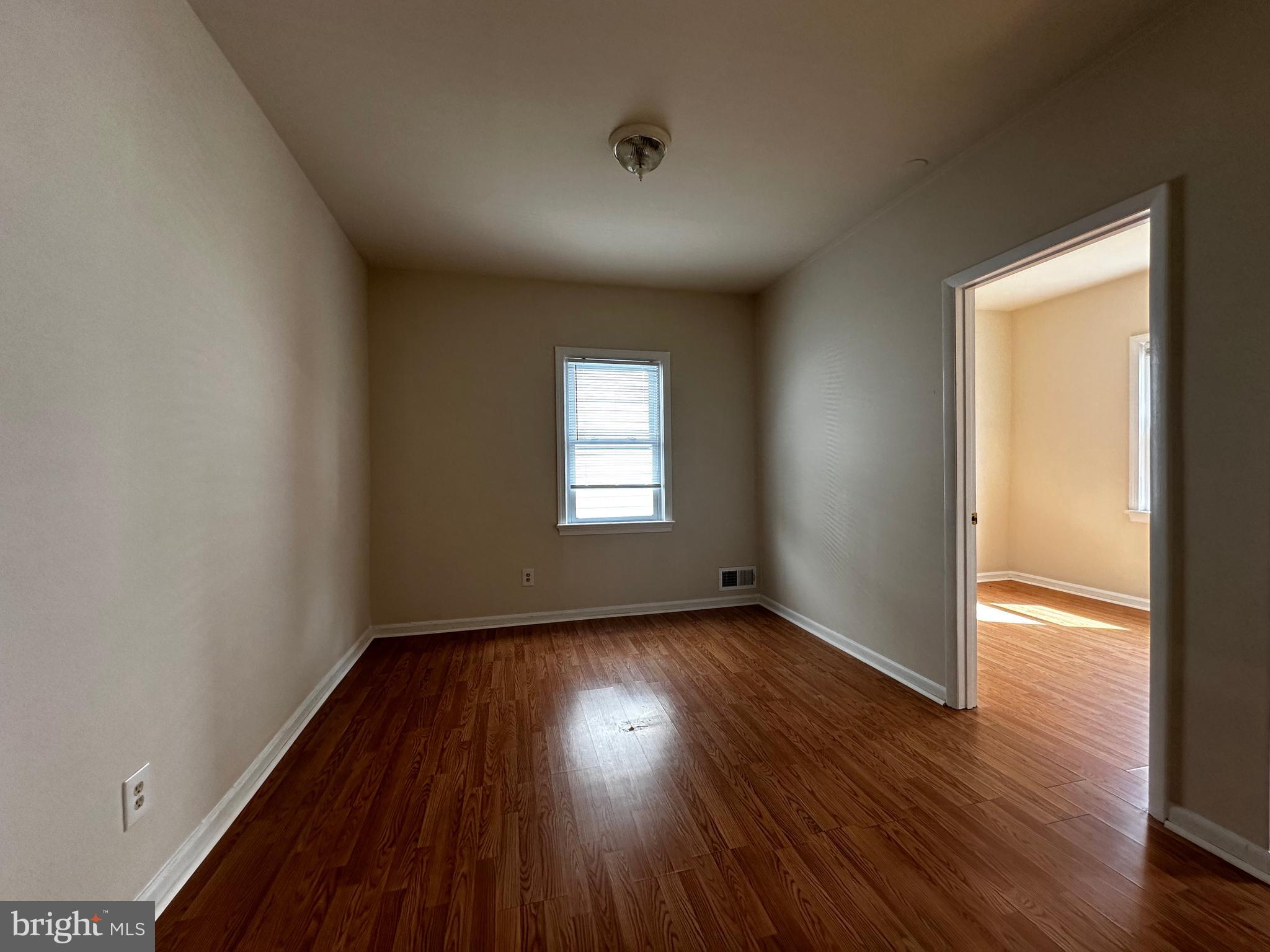 214 10th Street Laurel, MD 20707 - Photo 39 of 118 an empty room with wooden floor and windows