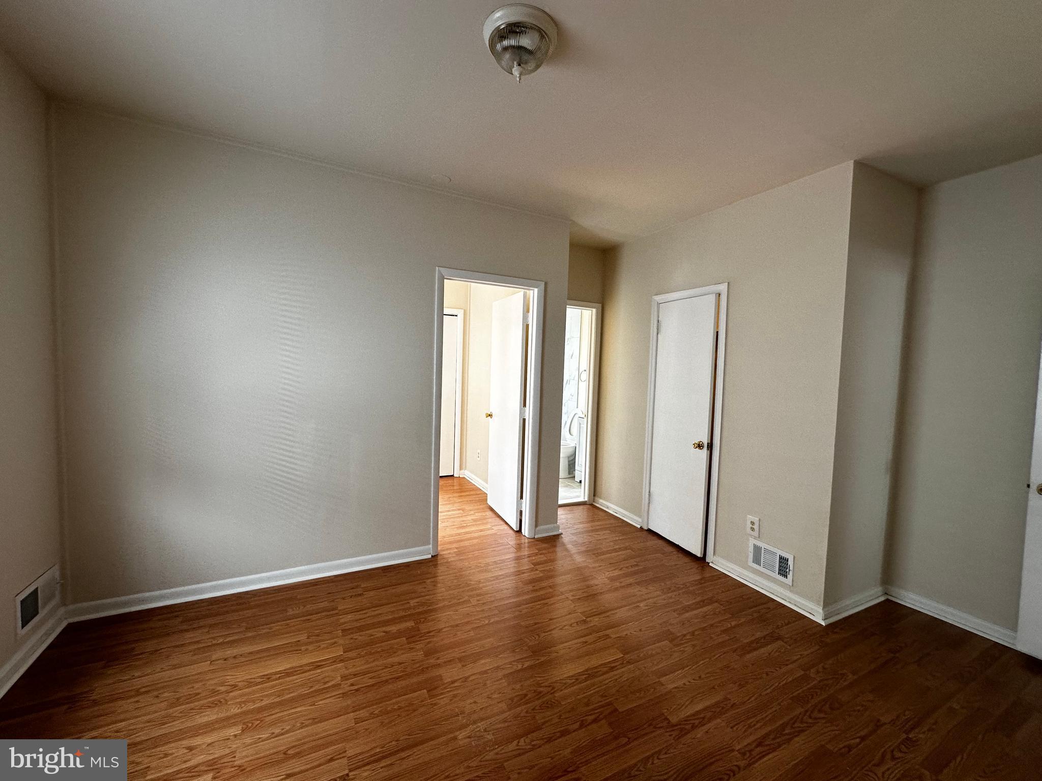 214 10th Street Laurel, MD 20707 - Photo 40 of 118 a view of an empty room with wooden floor