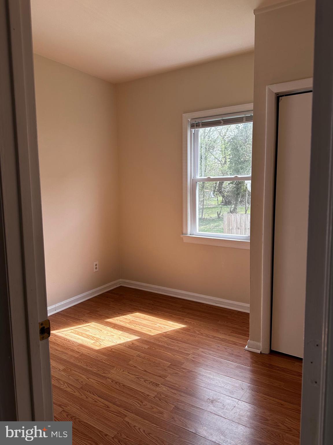 214 10th Street Laurel, MD 20707 - Photo 41 of 118 an empty room with wooden floor and windows