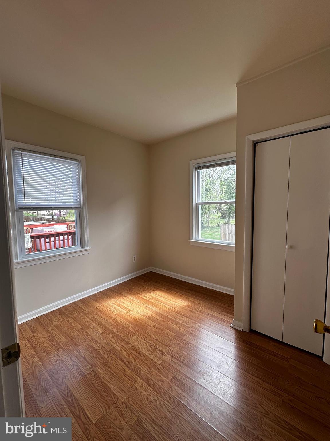 214 10th Street Laurel, MD 20707 - Photo 42 of 118 an empty room with wooden floor and windows