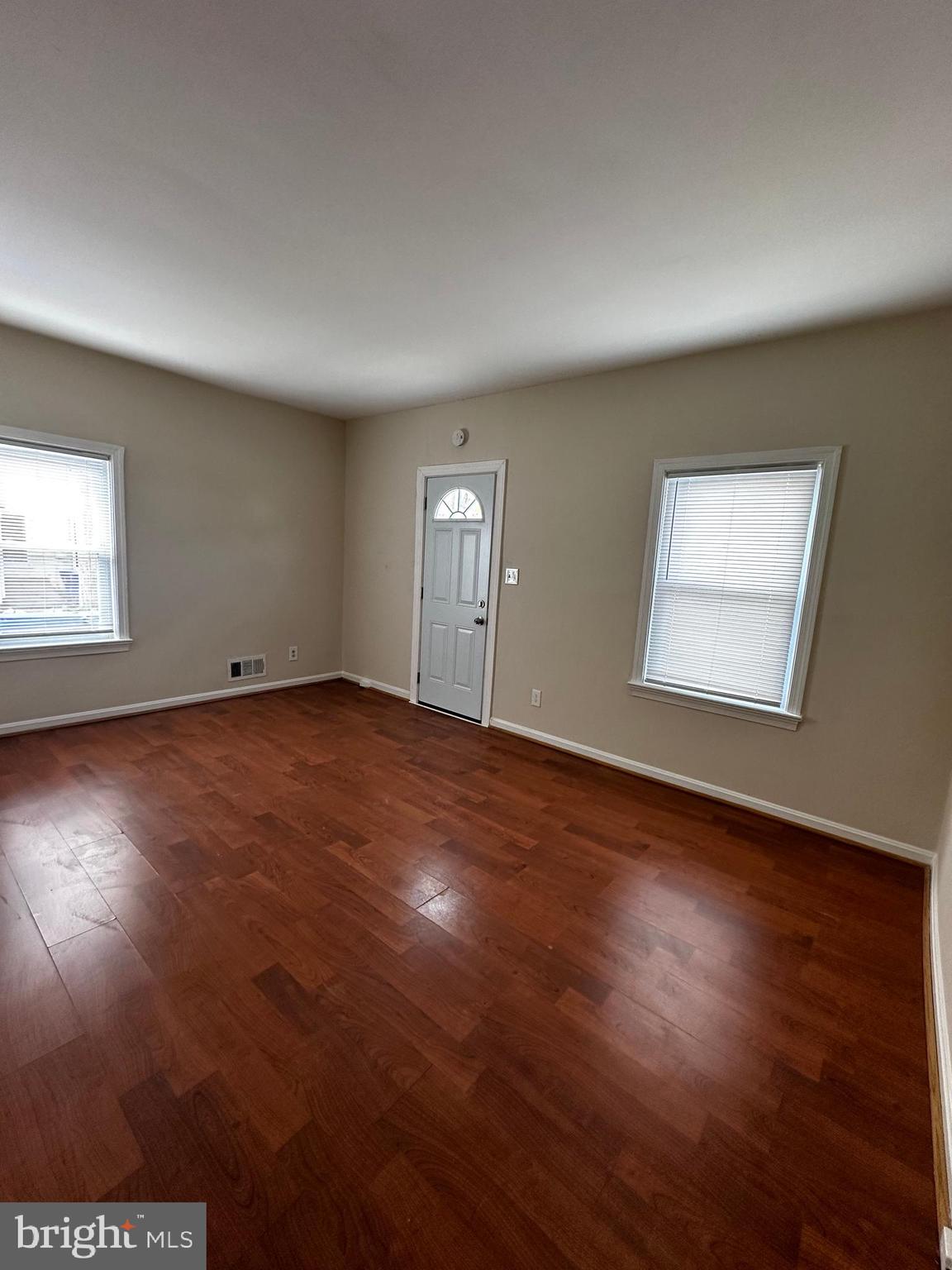 214 10th Street Laurel, MD 20707 - Photo 55 of 118 a view of an empty room with wooden floor and a window