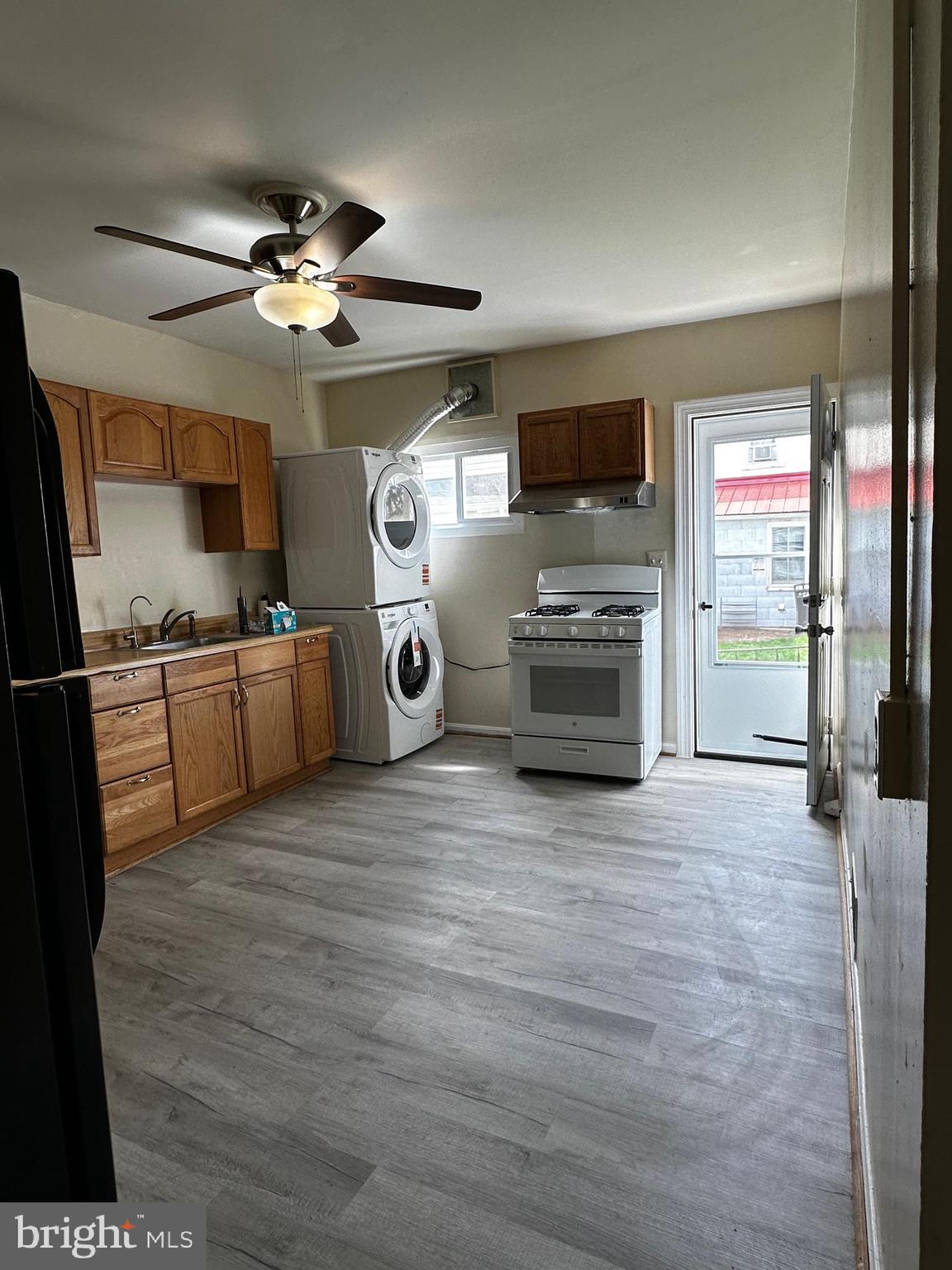 214 10th Street Laurel, MD 20707 - Photo 58 of 118 a view of a livingroom with furniture a flat screen tv and kitchen view