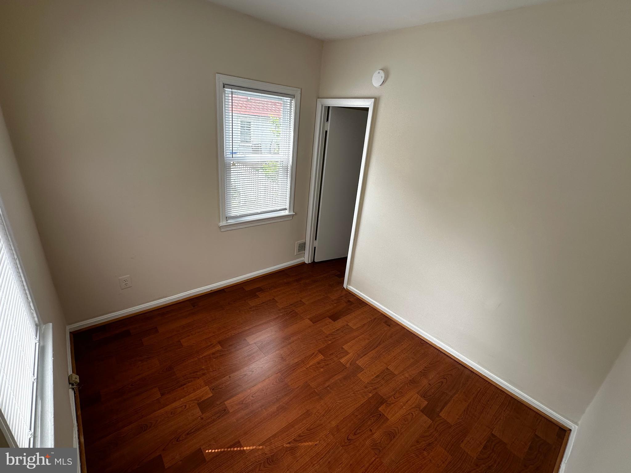 214 10th Street Laurel, MD 20707 - Photo 71 of 118 an empty room with wooden floor and windows