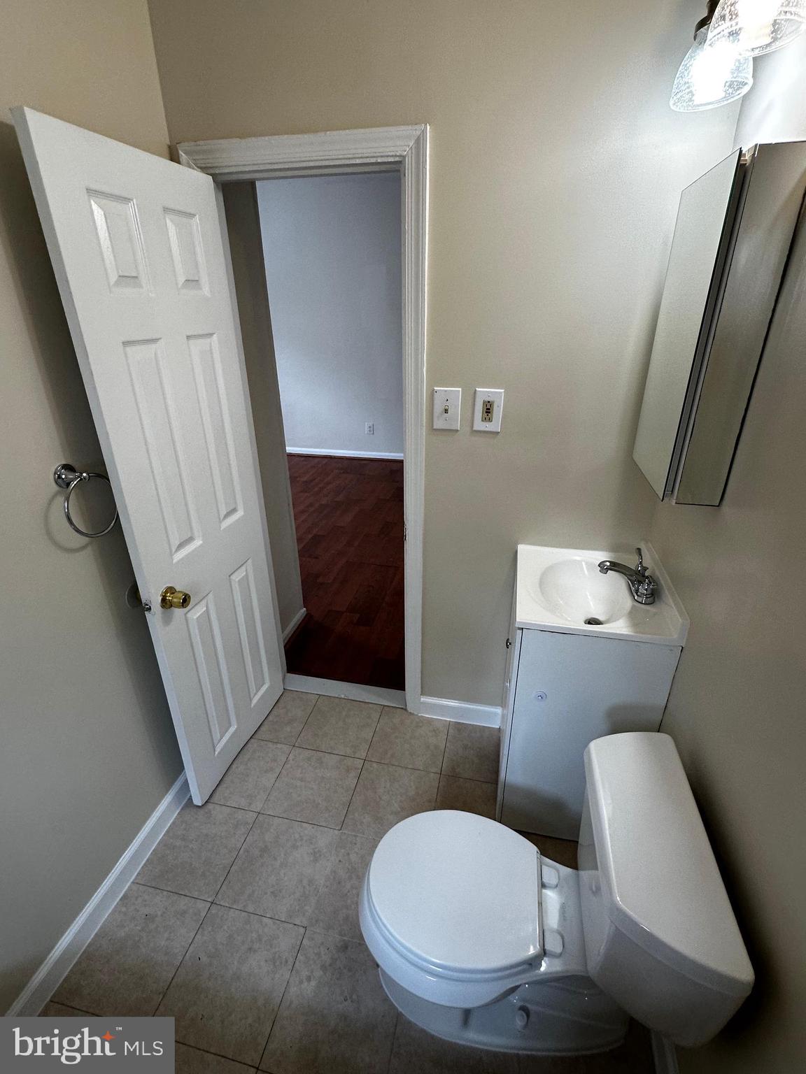 214 10th Street Laurel, MD 20707 - Photo 76 of 118 a bathroom with a toilet and a mirror