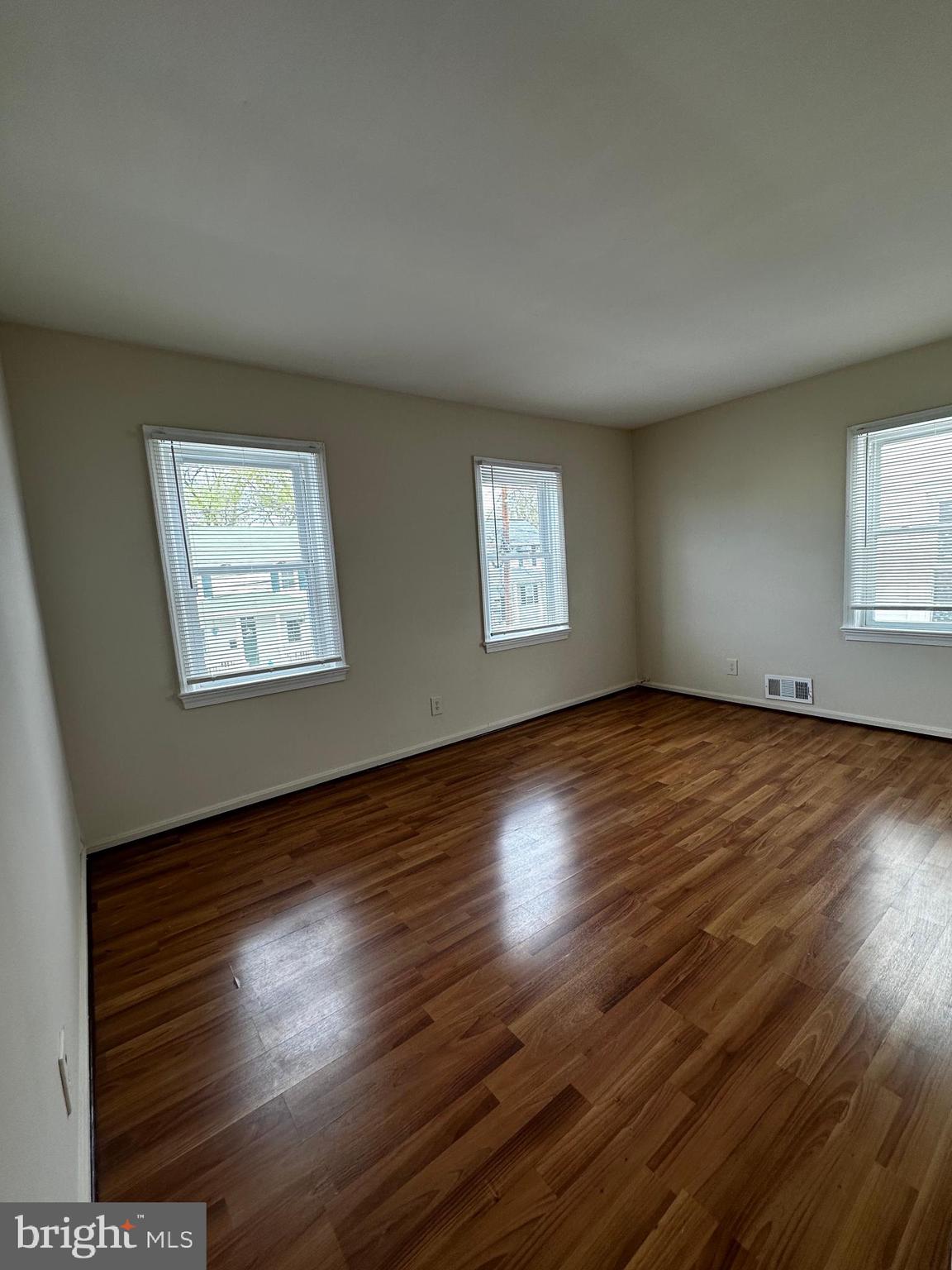 214 10th Street Laurel, MD 20707 - Photo 81 of 118 a view of an empty room with wooden floor and a window